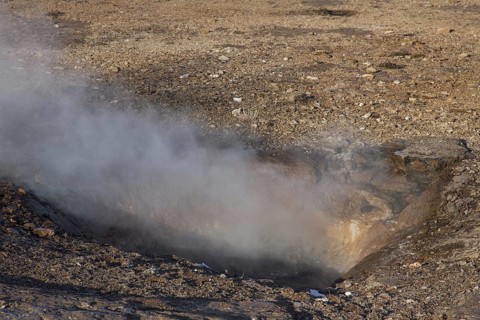 Steam coming from Litli Geysir in the geothermal area beside the Hvita River