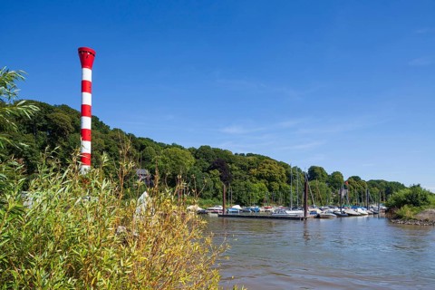 Dinghy harbour or Muehlenberg marina with lighthouse on the Elbe