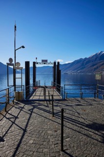 Backlit photograph of the jetty on Lake Maggiore in Ascona