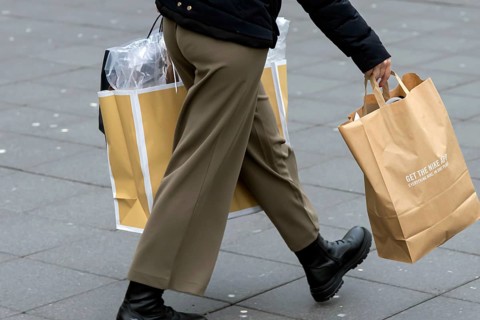 Consumer tourist lugging shopping bags