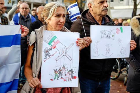 Iranian participants in the demonstration Solidarity March with Israel show posters and Israeli flags