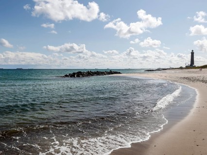 Baltic Sea beach with lighthouse in Skagen. Skagen is the only town in Denmark that lies on the North Sea and the Baltic Sea