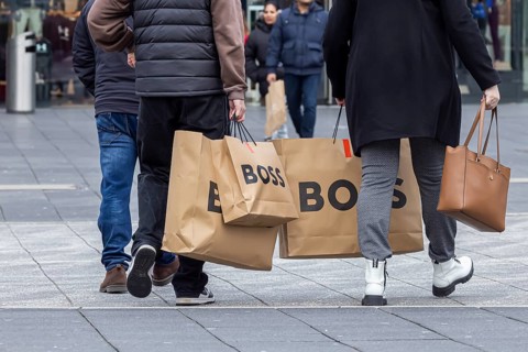 Consumer tourist lugging shopping bags