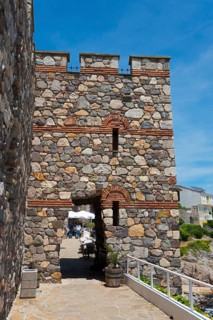 Old stone gate of a fortress under a clear blue sky