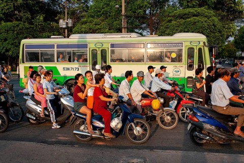 Mopeds and bus in the streets of Saigon