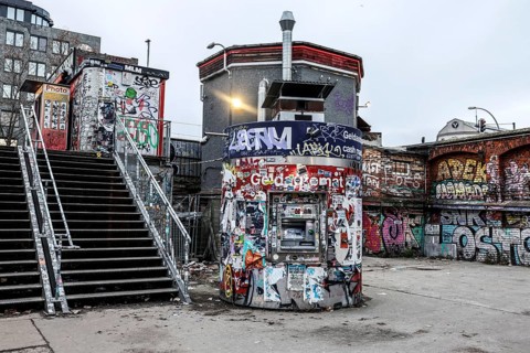 ATM with graffiti and stickers on the RAW site. The RAW site is the former Reichsbahn repair works in the Friedrichshain district. Today