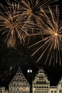 Colourful fireworks at night above the mediaeval facades at the Graslei