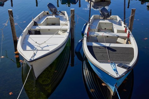 Motorboats moored to duckboards on Lake Maggiore in Ascona