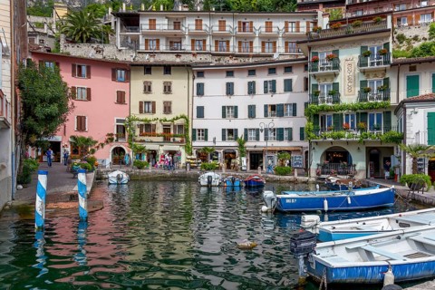 Houses and fishing boats in the old harbour of Limone sul Garda