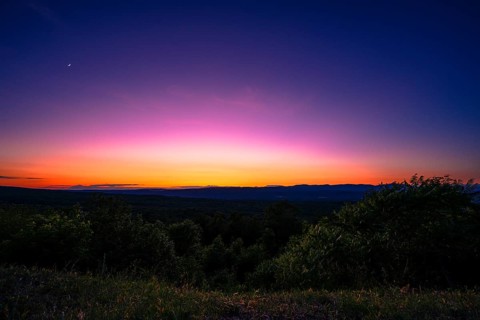 Sun sets behind the Catskills Mountains