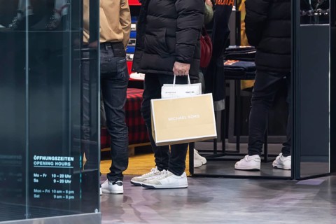 Consumer tourist lugging shopping bags