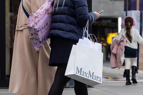 Consumer tourist lugging shopping bags