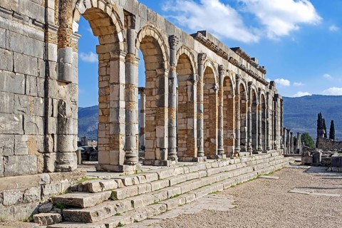 Arched outer wall of basilica faced with columns at Volubilis