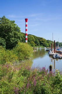 Dinghy harbour or Muehlenberg marina with lighthouse on the Elbe