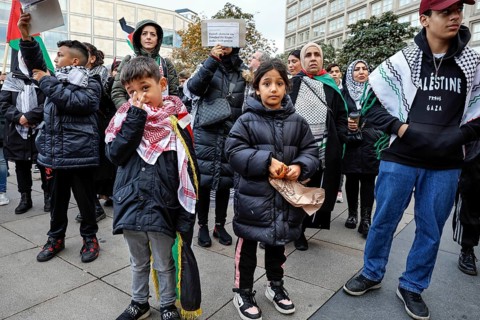 A young boy shows the peace sign during the demonstration Freedom for the people of Gaza