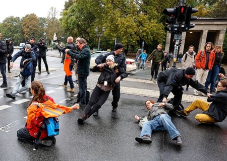 Police officers carry last generation climate activists from Strasse des 17. The Last Generation has called for a mass occupation action