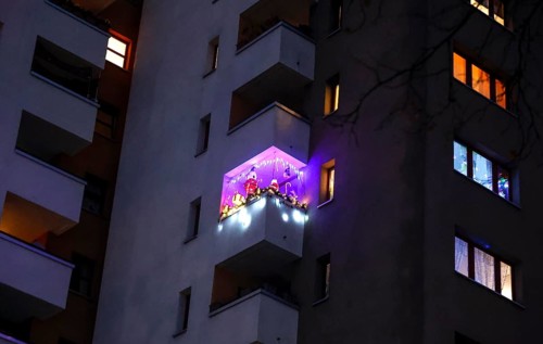 Balcony decorated for Christmas with LED fairy lights on a high-rise building in the Maerkisches Viertel