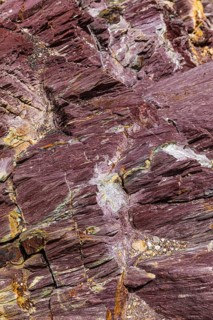 Coloured, ferrous mineral rocks on the beach of Topinetti, near Rio Marina, Elba, Tuscan
