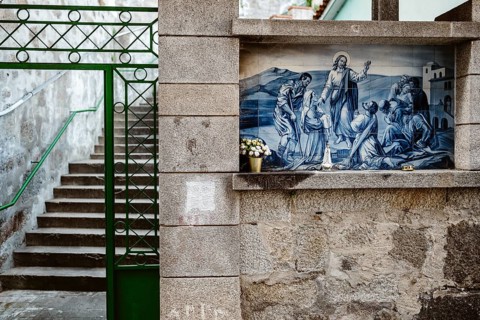 Holy Mary statue with the religious background made of Portuguese traditional tiles, Porto,