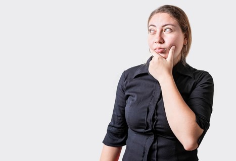 Young woman thinking with hand on chin isolated. Thoughtful beautiful girl with hand on chin