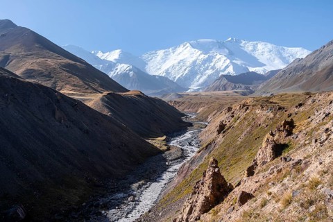 Valley with river Achik Tash between high mountains, mountain landscape with peak Pik Lenin, Osh