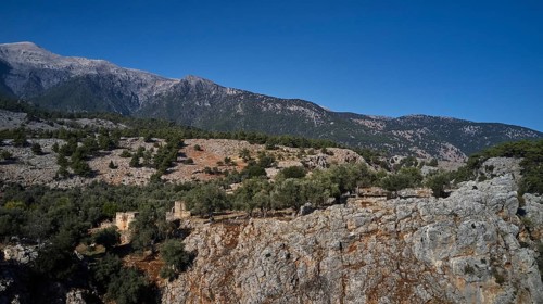 Ruins of old buildings against the majestic backdrop of a mountain, Aradena Gorge, Aradena, Sfakia,