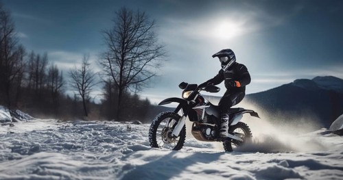 Motocross on an enduro motorcycle in the snow in winter, a motorcyclist in equipment and a helmet