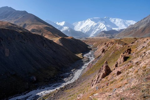 Valley with river Achik Tash between high mountains, mountain landscape with peak Pik Lenin, Osh