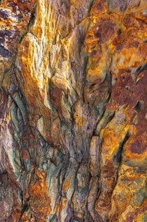 Coloured, ferrous mineral rocks on the beach of Topinetti, near Rio Marina, Elba, Tuscan