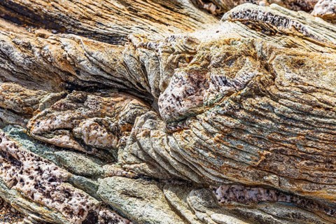 Coloured, ferruginous mineral sandstone on Topinetti beach, near Rio Marina, Elba, Tuscan