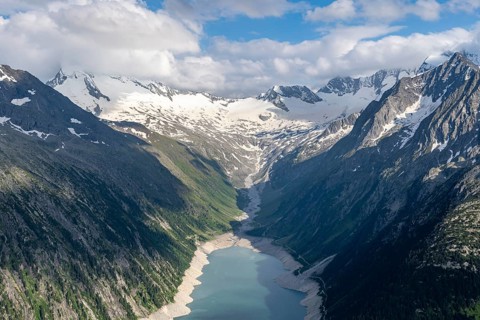 Picturesque mountain landscape near the Olpererhuette, view of turquoise-blue Schlegeisspeicher