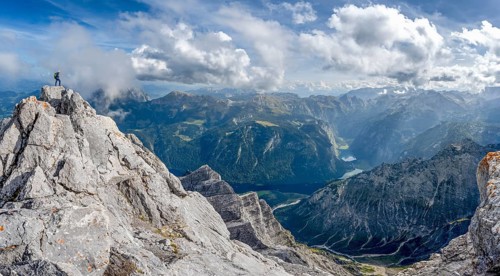 Mountaineer on the rocky summit of the Watzmann Mittelspitze, Watzmann crossing, view of mountain