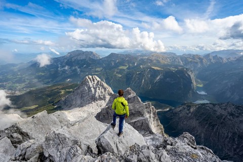 Mountaineer on the rocky summit of the Watzmann Mittelspitze, Watzmann crossing, view of mountain