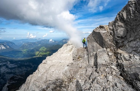 Mountaineer on a narrow rocky ridge, Watzmann crossing to Watzmann Mittelspitze, view of mountain
