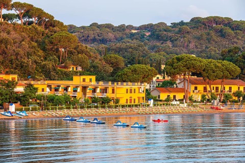 Pedal boats, sun loungers and parasols on the beach at Naregno at sunrise, near Capoliveri, Elba,
