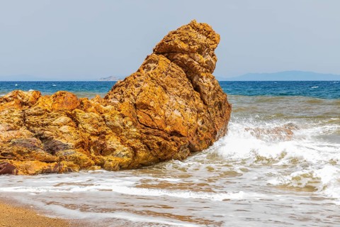 Mineral rock washed by the sea on the beach of Topinetti, near Rio Marina, Elba, Tuscan