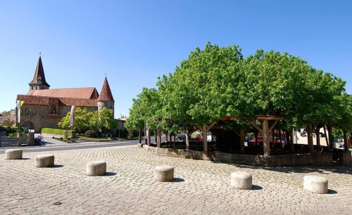Effeltrich, St George's fortified church and thousand-year-old dancing lime tree. The fortified