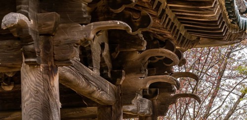 View of underside of roof of an old, unused oriental pavilion in a wooded area in South Korea