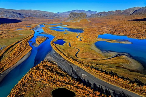 Aerial view of river delta with mountains in autumn, Rapadalen and Nammatj, Laponia, Lapland,