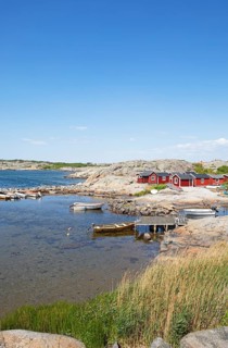 Red wooden houses on the archipelago island of Hoenoe, Oeckeroe municipality, Vaestra Goetalands