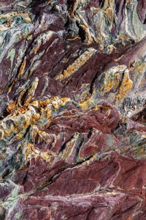 Coloured, ferrous mineral rocks on the beach of Topinetti, near Rio Marina, Elba, Tuscan