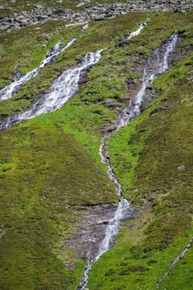 Waterfalls on a green mountainside, Berliner Hoehenweg, Zillertal Alps, Tyrol, Austria, Europe