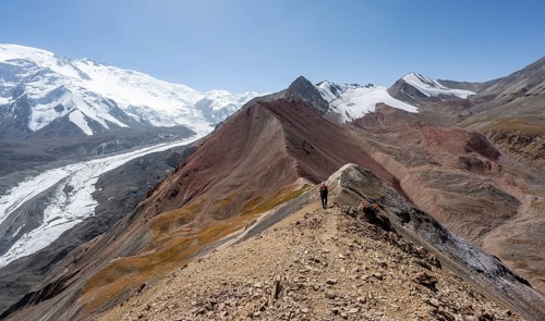 Mountaineer at Traveller's Pass with view of impressive mountain landscape, high mountain landscape