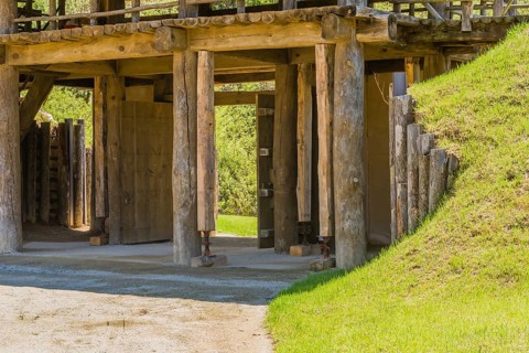 Wooden gate of traditional village made of logs and wooden planks with house jacks holding up