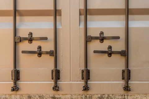 Fake door levers and rods on side of metal exterior wall