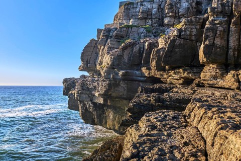 Beautiful cliffs and rock formations in Peniche, Portugal, on sunny day. Weathered rock formations,