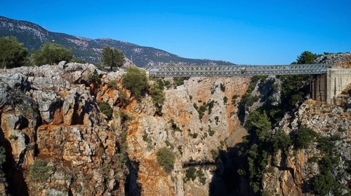 Metallic bridge over a deep gorge surrounded by a mountainous landscape, Aradena Gorge, Aradena,