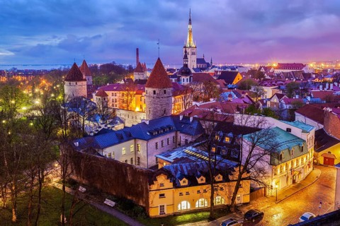 Aerial view of Tallinn Medieval Old Town with St. Olaf's Church and Tallinn City Wall illuminated