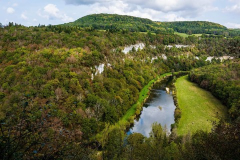 River with gorge and autumnal coloured forest, valley of the Loue, Lizine, near Besancon,