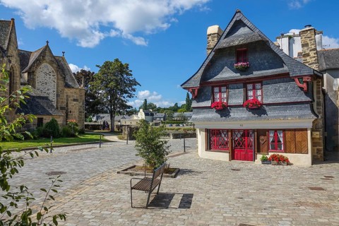 Rue du General de Gaulle in the old town centre of Le Faou with slate-roofed granite houses from